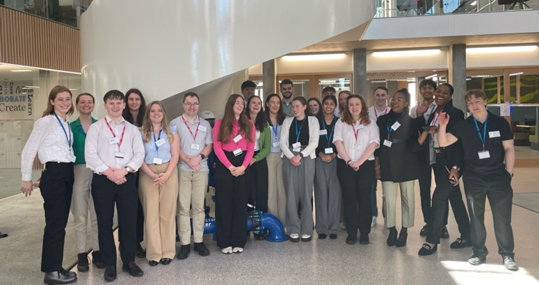 Group of interns standing in an office