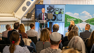 ACM 2025 View of audience attending the annual ACM at Dundee Science Centre with CEO Alex Plant at the lecturn