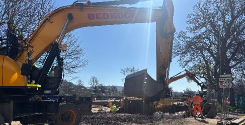 'Super Sewer' project along Tay Street and Shore Road reaches final stages. A digger sits at the forefront with construction workers in the background and a blue sky overhead.