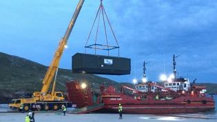 A new Water Treatment Work is unloaded on the beach at Huisinis, North Harris