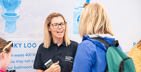 Draft Long Term Strategy Our Sustainable Future Together launch Female Scottish Water staff member talking to a woman and young girl