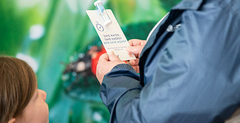 Draft Long Term Strategy Our Sustainable Future Together launch Unknown member of the public with a young child holding a shower timer