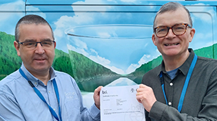 BSI Certificate for Carbon Reduction Scottish Water's General Manager Gordon Reid and Delivery Manager Ian Watt with BSI certificate