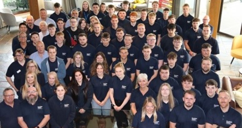 Scottish Apprenticeship Week 2025 Group of people in matching Scottish Water branded polo shirts posing for a photo indoors