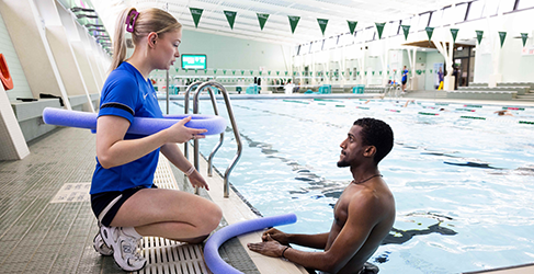 Never too Late Learn to Swim Learn to Swim instructor Lucy McCluskey talks to Ammanuel Akulu in the pool at his adult swimming lesson