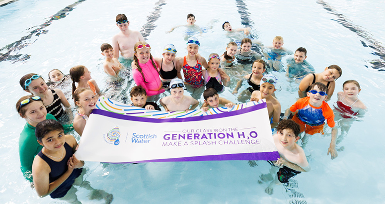 Generation H2O Make a Splash Winning Class Children in a pool holding a Generation H2O sign
