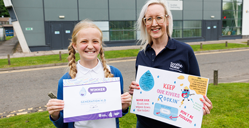 Generation H2O Make a Splash Winning Class Scottish Water employee Lorna Neilson with poster designed by winner Anna Lynas