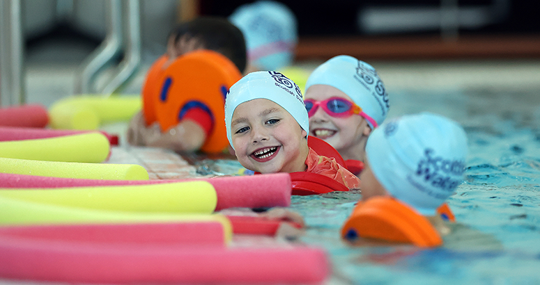 Learn to Swim Partnership 200K Milestone kids in pool with floats