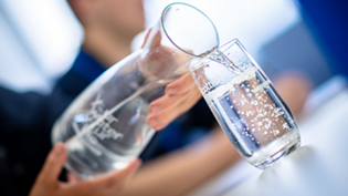 Jug of water pouring into a glass
